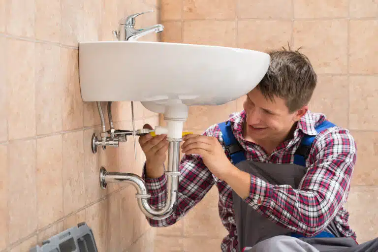 Plumber Fixing A Bathroom Leak