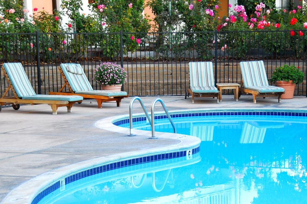 Swimming Pool Surrounded by Chairs and Flowers — Leak Detection in Tweed Heads, NSW